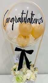 12 White flowers basket with a hot air bubble balloon saying congratulations stuffed with gold and white balloons